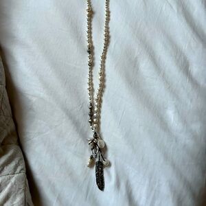 Pearl like beads with feather and pearl charm.